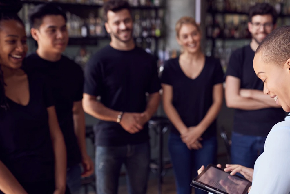 group of young adults standing with a supervisor